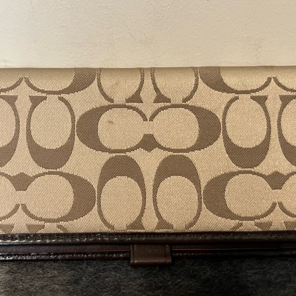 Coach checkbook cover.